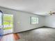 Inviting living room featuring an open front door and fresh carpet at 9886 Se 178Th Ln, Summerfield, FL 34491