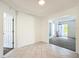 Open-plan living room with tile floors and a view of the doorway and front entrance at 9886 Se 178Th Ln, Summerfield, FL 34491