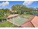 Active community shuffleboard courts feature covered seating areas, a pond, and lush landscaping for the ultimate outdoor recreation at 9886 Se 178Th Ln, Summerfield, FL 34491