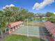 Active community shuffleboard courts feature covered seating areas, a pond, and lush landscaping for the ultimate outdoor recreation at 9886 Se 178Th Ln, Summerfield, FL 34491
