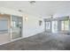 Enclosed sunroom features carpet floors, ceiling fan, large windows offering views of the outside, and sliding door access at 9886 Se 178Th Ln, Summerfield, FL 34491