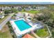 Aerial view of a sparkling blue pool with sun loungers and a jacuzzi, perfect for relaxation at 9886 Se 178Th Ln, Summerfield, FL 34491