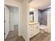 Bathroom featuring granite countertop vanity and gray-tiled shower at 1370 Sw Obee Ridge Rd, Dunnellon, FL 34432
