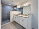 Modern bathroom with double sinks, granite countertops, white cabinets and a glass-enclosed shower at 1370 Sw Obee Ridge Rd, Dunnellon, FL 34432