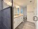 Well-lit bathroom with granite counters, double sinks, updated fixtures, and a shower with gray tiles at 1370 Sw Obee Ridge Rd, Dunnellon, FL 34432