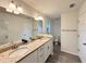 Bright bathroom with dual sinks, granite countertop, and modern fixtures, creating an elegant space at 1370 Sw Obee Ridge Rd, Dunnellon, FL 34432