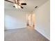 View of a light, airy carpeted bedroom with ceiling fan and an open doorway to closet at 1370 Sw Obee Ridge Rd, Dunnellon, FL 34432