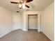 Carpeted bedroom with ceiling fan and a large closet at 1370 Sw Obee Ridge Rd, Dunnellon, FL 34432