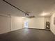 Spacious two-car garage with epoxy floor and ample room for storage and access to interior at 1370 Sw Obee Ridge Rd, Dunnellon, FL 34432