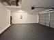 Two-car garage with epoxy flooring and door that grants access to the exterior of the home at 1370 Sw Obee Ridge Rd, Dunnellon, FL 34432