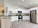 Bright open kitchen showcases modern stainless appliances, granite countertops and plenty of white cabinetry at 1370 Sw Obee Ridge Rd, Dunnellon, FL 34432