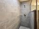 Contemporary shower with gray tile, glass door, and upgraded shower head at 1370 Sw Obee Ridge Rd, Dunnellon, FL 34432