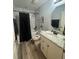 Clean bathroom with modern vanity, bathtub, and updated fixtures at 13949 Se 53Rd Ave, Summerfield, FL 34491