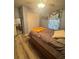 Well-lit bedroom with wood floors, closet, and window with curtains at 13949 Se 53Rd Ave, Summerfield, FL 34491