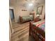 Bedroom featuring two twin beds, wood floors, and bright sunlight at 13949 Se 53Rd Ave, Summerfield, FL 34491