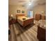 Comfortable bedroom with wood flooring, ceiling fan, and traditional furniture at 13949 Se 53Rd Ave, Summerfield, FL 34491