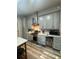 Well-equipped kitchen with stainless steel appliances, custom cabinets, and beverage refrigerator at 13949 Se 53Rd Ave, Summerfield, FL 34491