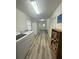 Large, well-lit laundry room equipped with washer, dryer, and additional storage space at 13949 Se 53Rd Ave, Summerfield, FL 34491
