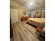 Comfortable main bedroom with a neutral color palette and wood-look flooring at 13949 Se 53Rd Ave, Summerfield, FL 34491