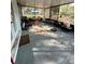 Enclosed sunroom with seating area and view of the backyard at 13949 Se 53Rd Ave, Summerfield, FL 34491