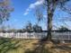 Backyard featuring a white picket fence, a mature tree, and green grass at 1645 Sw 168Th Loop, Ocala, FL 34473