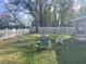 Spacious backyard with green grass, a white fence, and scattered seating arrangements at 1645 Sw 168Th Loop, Ocala, FL 34473