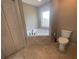 Bathroom features a tiled soaking tub and a separate toilet room and closet at 1645 Sw 168Th Loop, Ocala, FL 34473