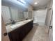 Bathroom with double sink vanity, large mirror, and tile floor at 1645 Sw 168Th Loop, Ocala, FL 34473
