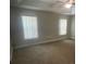View of a carpeted bedroom with vertical blinds on the windows at 1645 Sw 168Th Loop, Ocala, FL 34473