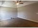 Features a carpeted bedroom with ceiling fan and tray ceiling at 1645 Sw 168Th Loop, Ocala, FL 34473