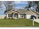 Charming single-story home with a well-manicured lawn, neutral exterior, and attached two-car garage at 1645 Sw 168Th Loop, Ocala, FL 34473