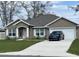Charming single-story home with a well-manicured lawn, neutral exterior, and attached two-car garage at 1645 Sw 168Th Loop, Ocala, FL 34473