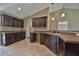 Well-lit kitchen featuring dark wood cabinets, granite countertops, and stainless steel sink at 1645 Sw 168Th Loop, Ocala, FL 34473