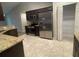 View of the kitchen with stainless steel appliances and adjacent pantry and tile floors at 1645 Sw 168Th Loop, Ocala, FL 34473