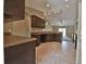 Open-concept kitchen with dark wood cabinets and granite countertops flowing into living area at 1645 Sw 168Th Loop, Ocala, FL 34473
