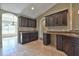 Spacious kitchen showcasing dark wood cabinets and granite countertops with tile flooring at 1645 Sw 168Th Loop, Ocala, FL 34473