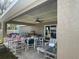 Covered patio area furnished with patio furniture, tables, and a ceiling fan for outdoor enjoyment at 1645 Sw 168Th Loop, Ocala, FL 34473
