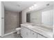 Bathroom features a shower, white vanity, granite countertop and brushed nickel faucet at 17672 Sw 112Th Ln, Dunnellon, FL 34432