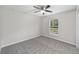 Bedroom features a window overlooking the green yard and ceiling fan at 17672 Sw 112Th Ln, Dunnellon, FL 34432