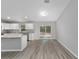 Modern kitchen with white cabinets, an island, and stainless steel appliances, ideal for Gathering meals at 17672 Sw 112Th Ln, Dunnellon, FL 34432