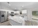 Bright kitchen featuring stainless steel appliances, ample cabinet space, and an island at 17672 Sw 112Th Ln, Dunnellon, FL 34432