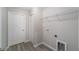 Laundry room featuring a utility sink, storage shelf, and wood-look flooring at 17672 Sw 112Th Ln, Dunnellon, FL 34432