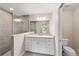 This bathroom has a vanity with marble top, and a glass-enclosed shower with grey tile at 17718 Sw 112Th Ln, Dunnellon, FL 34432