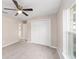 This bedroom has carpeted floor and features a ceiling fan and a closet with white doors at 17718 Sw 112Th Ln, Dunnellon, FL 34432