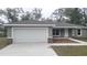 Charming single-story home with a two-car garage and a well-maintained lawn at 17718 Sw 112Th Ln, Dunnellon, FL 34432