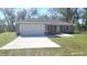 Charming single-story home with a two-car garage and a well-maintained lawn at 17718 Sw 112Th Ln, Dunnellon, FL 34432