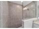 This bathroom features a glass enclosed shower with grey tile and shower head at 17718 Sw 112Th Ln, Dunnellon, FL 34432