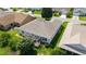 An aerial view shows the house with a screened patio and mature trees on a sunny day at 17959 Se 89Th Natchez Ave, The Villages, FL 32162