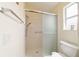 Modern bathroom featuring a walk-in shower with glass doors, plus a toilet and decor at 17959 Se 89Th Natchez Ave, The Villages, FL 32162