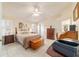 Inviting bedroom with tiled floor, natural light and a ceiling fan at 17959 Se 89Th Natchez Ave, The Villages, FL 32162